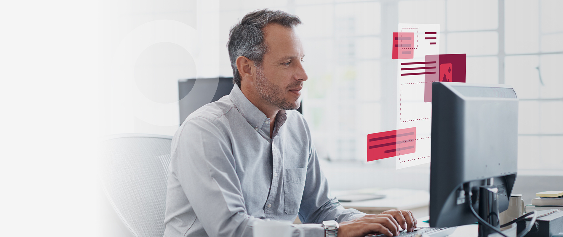 Office employee at his computer workstation who has to manage multiple data views and documents and relies on primedocs.